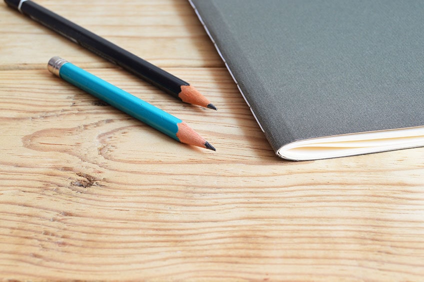 pencils and notebook on desk