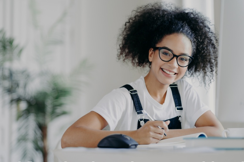 student working on her writing assignments