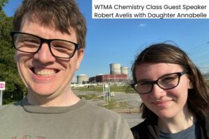 nuclear power plants behind smiling father and daughter