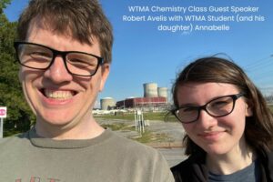 nuclear power plants behind smiling father and daughter