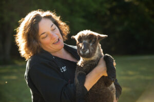 Dr. Susan Wise Bauer holds a little black lamb.