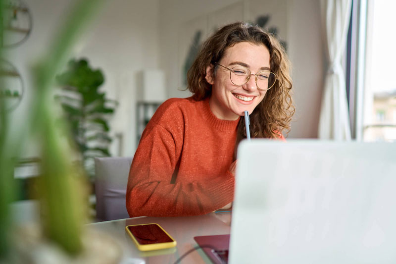 Young girl sits at desk enjoying online classical homeschool at the Well-Trained Mind Academy.
