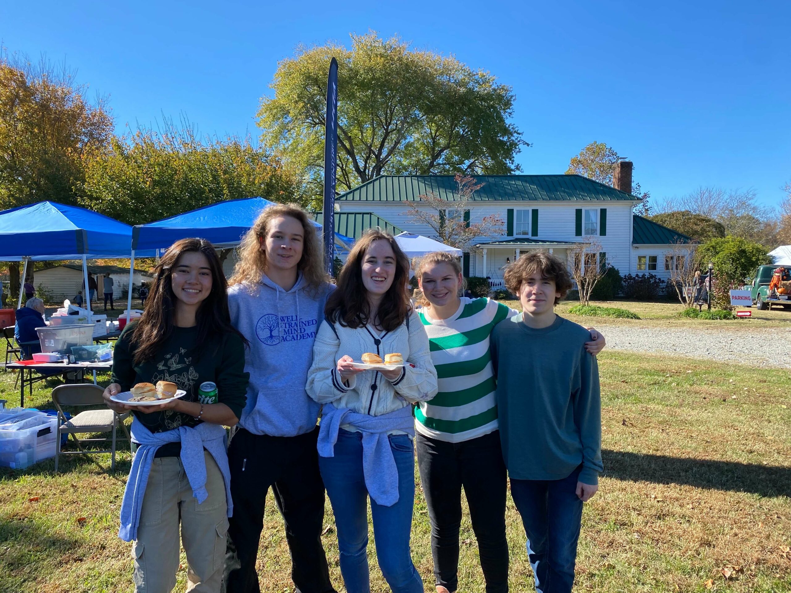 Students stand, having a great time at the 2023 fall fiber festival.