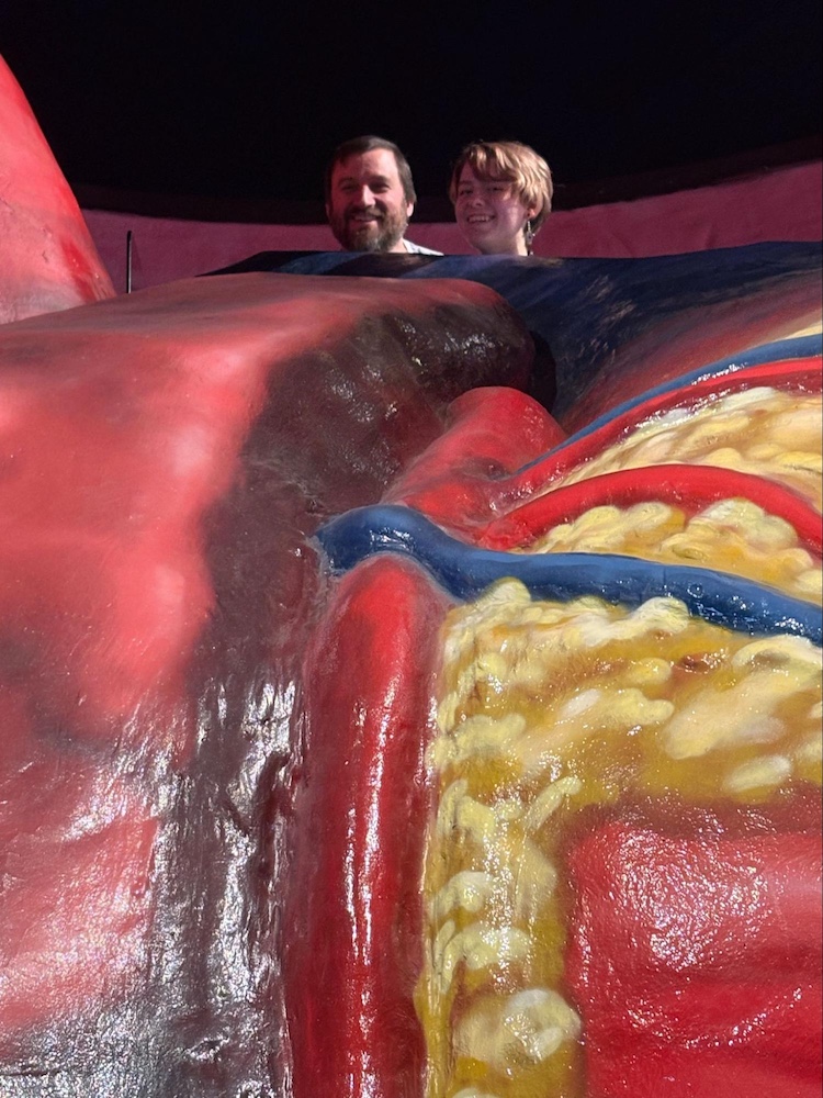 Ellie S. and her dad peeking out of a giant heart.