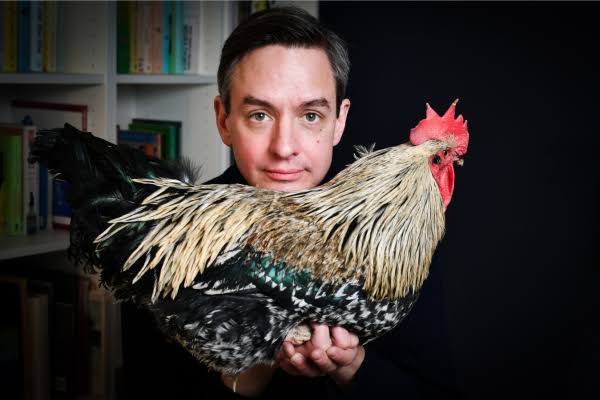 Justin Gregg with a chicken